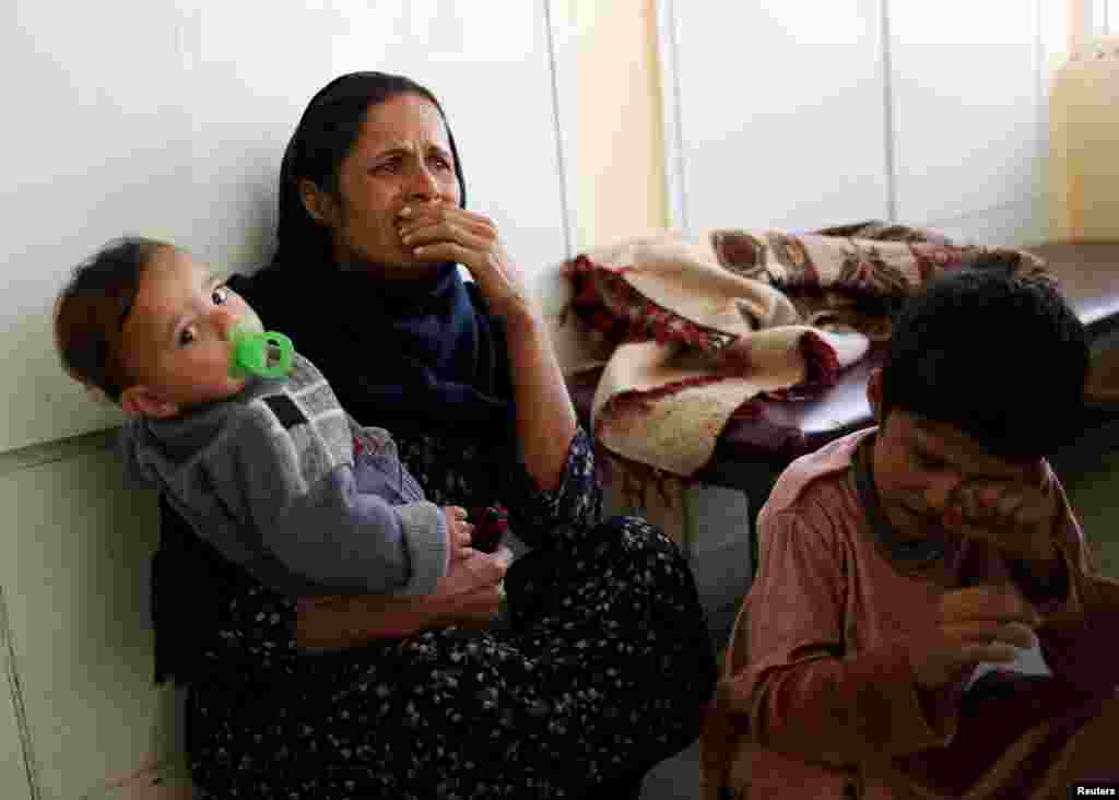 A woman reacts at the Indira Gandhi Children's hospital after explosions at the Sardar Mohammad Daud Khan National Military Hospital in Kabul, Afghanistan. The children's hospital was not attacked.