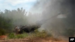 Українські військові обстрілюють позиції Росії з гаубиці M777, поставленої США, на сході України в Донецькій області, 18 червня 2022 року. (Фото AP/Єфрем Лукацький)