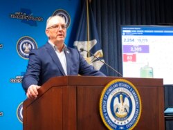 Louisiana Gov. John Bel Edwards answers questions from reporters about his state's rapid escalation of coronavirus cases, in Baton Rouge, La., March 26, 2020.