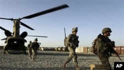 US infantrymen from the 101st Airborne Division and Afghan Army commandos exit a U.S. Army helicopter used to transport troops around Zhari District in Afghanistan's southern Kandahar province, 11 Sept. 2010.