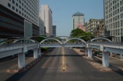 A car is seen on an empty street in downtown Yangon, Myanmar, March 24, 2021, during what anti-coup protesters called a "silent strike."