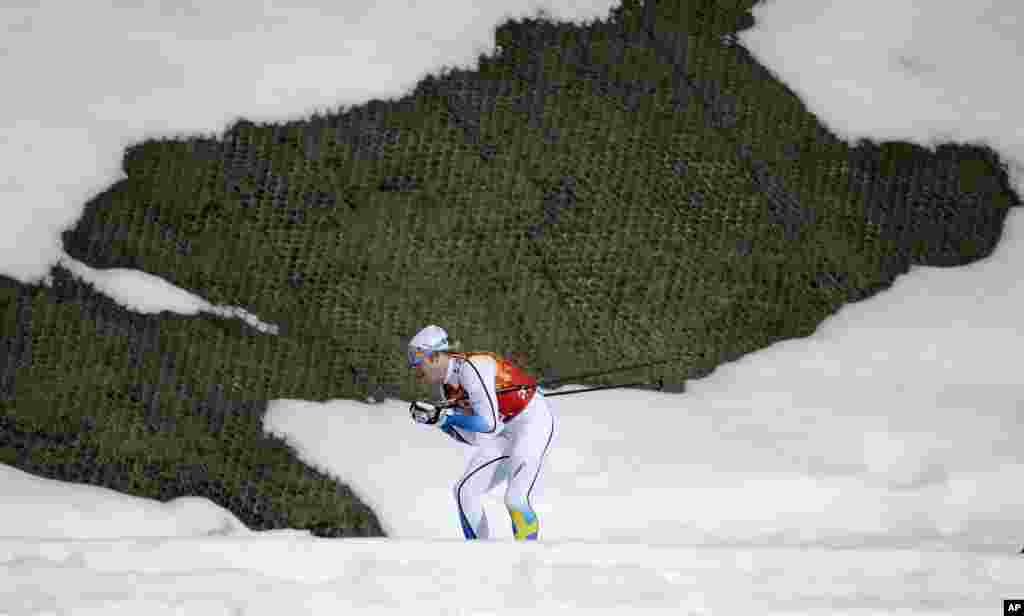 Sweden's Lars Nelson skis past a hole in the snow during the men's cross-country relay, Krasnaya Polyana, Russia, Feb. 16, 2014.