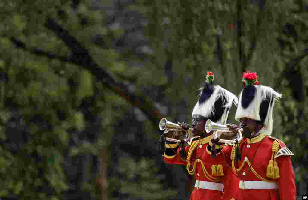 Members of a Kenyan military band sound bugles to mark the start of two minute-silence on Remembrance Sunday at the Nairobi War Cemetery. The annual event is observed in Britain and around the Commonwealth to honor the contribution of those British and Commonwealth military who died in the two World Wars and later conflicts. 
