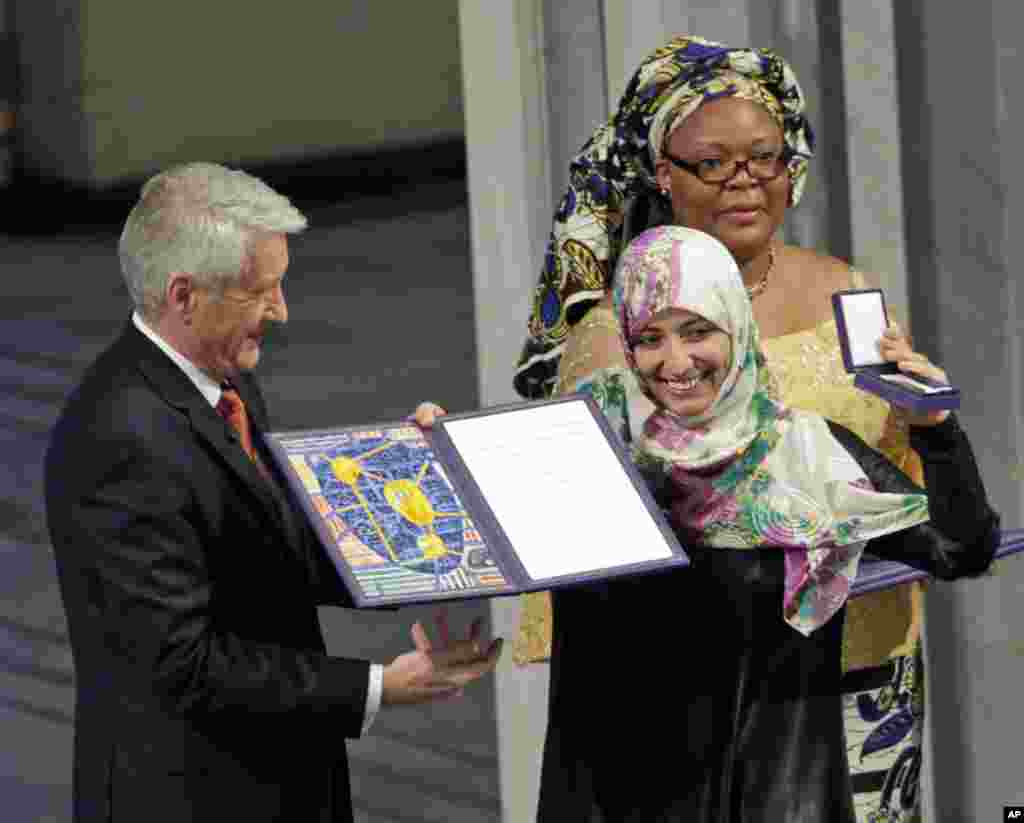December 10, 2011: Nobel Peace Prize winners Tawakkol Karman of Yemen, (C) and Liberian peace activist Leymah Gbowee (R) receive their diplomas and medals from Nobel Committee Chairman Thorbjoern Jagland (L) at City Hall in Oslo, Norway.