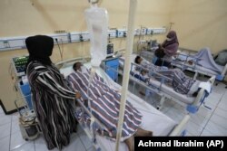 Relatives stand nearby as survivors of Saturday's deadly crush are treated at a hospital in Malang, East Java, Indonesia, on October 3, 2022. (AP Photo/Achmad Ibrahim)