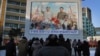 FILE - North Koreans gather in front of a portrait of their late leader Kim Il Sung, left, and Kim Jong Il, right, paying respects to their late leader Kim Jong Il, to mark the third anniversary of his death.