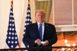 U.S. President Donald Trump poses on the Truman Balcony of the White House after returning from being hospitalized at Walter Reed Medical Center for coronavirus disease (COVID-19) treatment, in Washington, Oct. 5, 2020.