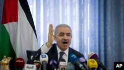 FILE - Palestinian Prime Minister Mohammed Shtayyeh chairs a cabinet meeting in the Jordan Valley village of Fasayil, Sept. 16, 2019. 