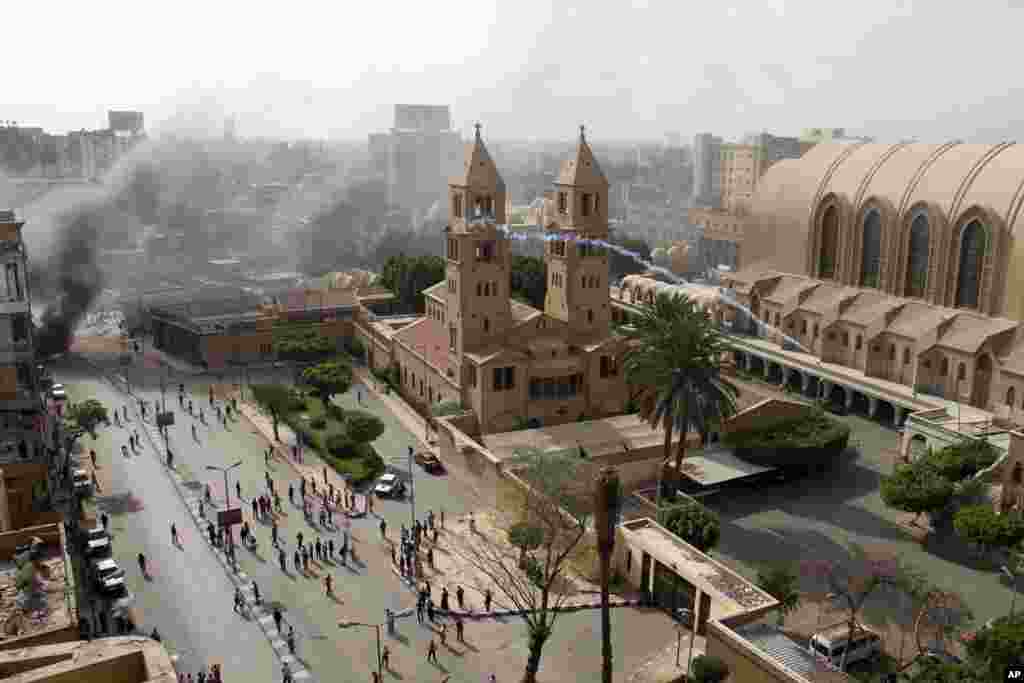 Egyptian riot police fire tear gas into the compound of the Coptic Orthodox Cathedral after the funeral of four Christians killed in sectarian clashes near Cairo, April 7, 2013.