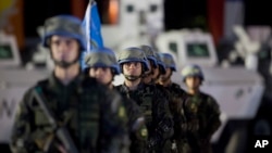 FILE - United Nations peacekeepers from Brazil stand at attention during the end of operations ceremony of the Brazilian battalion and engineering company, from the United Nations Stabilization Mission in Haiti, in Port-au-Prince, Aug. 31, 2017.