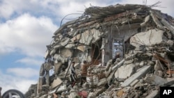 Displaced Palestinians inspect the ruins of their home, which was destroyed in the Israeli bombardment of the Gaza Strip, a day after the ceasefire deal between Israel and Hamas came into effect, Jan. 20, 2025.