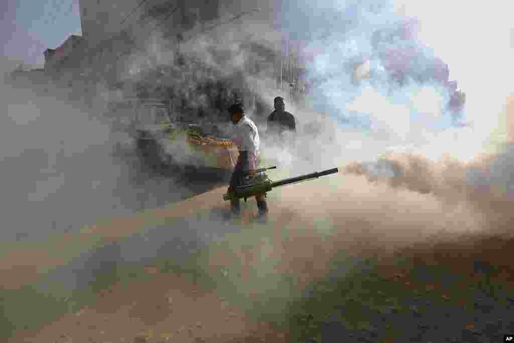 Disinfectant is sprayed in a market area in an effort to contain the outbreak of the coronavirus, in Karachi, Pakistan.