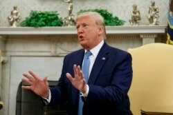 President Donald Trump speaks in the Oval Office of the White House, in Washington, July 22, 2019.