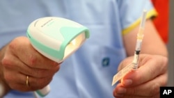 A vial of the Pfizer vaccine is scanned before administered at the Royal Prince Alfred Hospital Vaccination Hub in Sydney, Australia, Monday, Feb. 22, 2021. Australia has started its COVID-19 vaccination program days after its neighbor New Zealand…