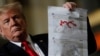 President Donald Trump shows maps of Syria and Iraq depicting the size of the "ISIS physical caliphate" as he speaks to workers at the country's only remaining tank manufacturing plant, in Lima, Ohio, March 20, 2019. 