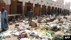 Soldiers guard a market in N'Djamena following a suicide bomb attack on July 11, 2015. 