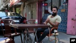 Lebanese Wissam al-Sheikh, 30, recently lost his job as manager at a clothes store, sitting idle at a coffee shop, as millions of youth in the Middle East region have had job prospects, plans for higher education and marriage upended by the pandemic.