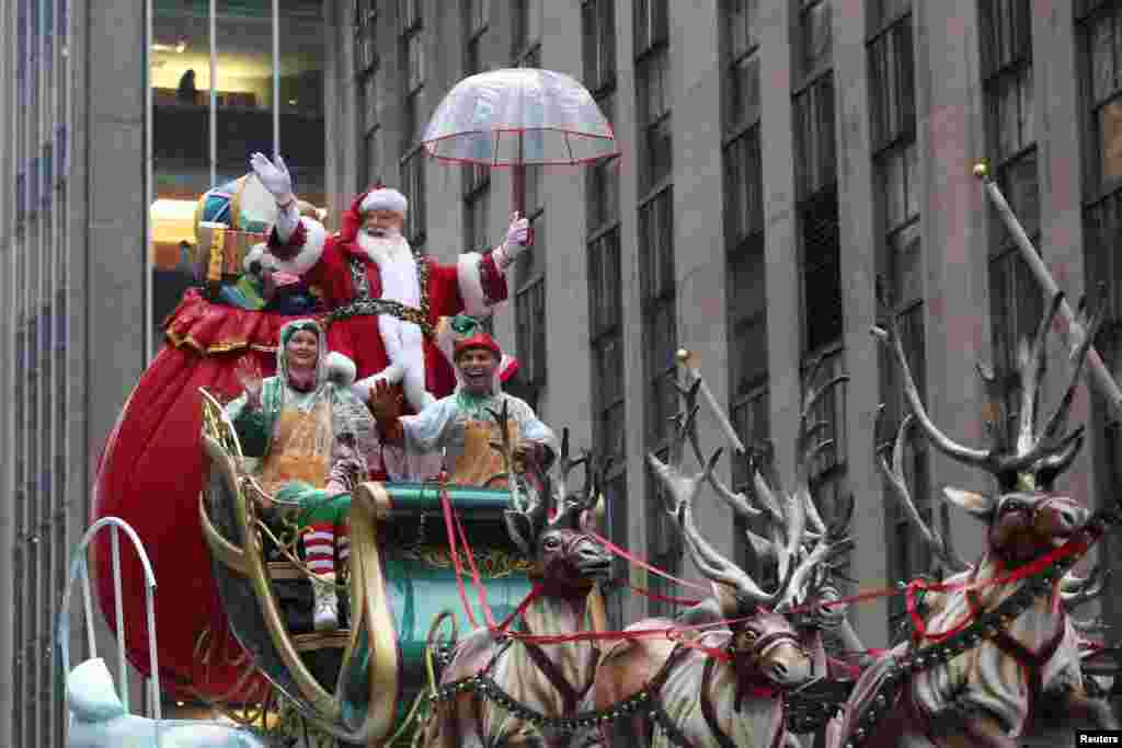A man dressed as Santa Claus gestures during the 98th Macy's Thanksgiving Day Parade in New York City.