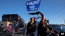 Supporters of President Donald Trump attend a rally and car parade Saturday, Aug. 29, 2020, in Clackamas, Ore., on the way to Portland. (AP Photo/Paula Bronstein )