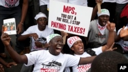 Kenyan demonstrators, march towards parliament in Nairobi, Kenya, June 11, 2013, as they protest against what they see as the greed of their legislator leaders. 