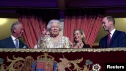 Britain's Queen Elizabeth waves next to Prince Charles and Prince William, Duke of Cambridge, during a special "The Queen's Birthday Party" concert to celebrate her 92nd birthday at the Royal Albert Hall in London, April 21, 2018.