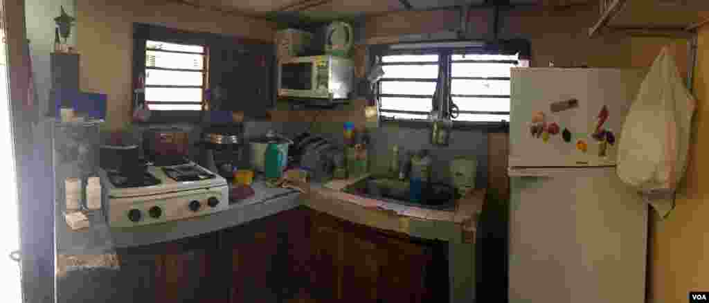 A working-class kitchen is seen in a Havana home, Aug. 13, 2015. New refrigerators are sometimes given out by the government. (Celia Mendoza/VOA)