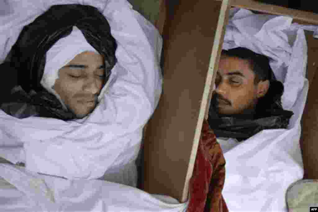 ** EDS NOTE GRAPHIC CONTENT ** This photograph, obtained by The Associated Press outside Libya and taken by an individual not employed by AP, shows dead bodies in coffins during recent days' unrest in Benghazi, Libya. (AP Photo) EDITOR'S NOTE: THE AP HAS