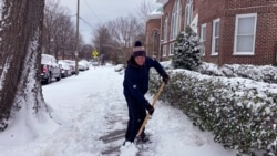 Richard Fuller, de 45 años, palea una acera en Norfolk, Virginia, el sábado 22 de enero de 2022.