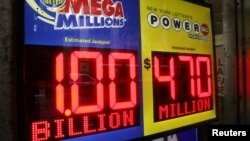 Signs display the jackpots for Mega Millions and Powerball lottery drawings at a newsstands in midtown Manhattan in New York, Oct. 19, 2018.