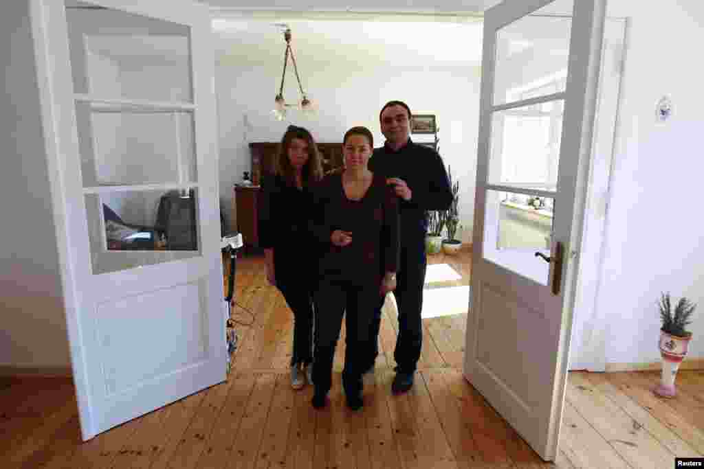 Jozef Walukiewicz, his wife Anna and daughter Katarzyna stand inside their renovated house in the village of Rosow, Germany, located near the Polish border, April 7, 2013.