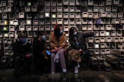 People take a selfie in a shopping mall in Wuhan, Hubei province, China, Jan. 22, 2021.