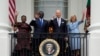 First lady Jill Biden and President Joe Biden, along with Kenya's President William Ruto and his wife Rachel Ruto, wave from the Blue Room Balcony during a State Arrival Ceremony on the South Lawn of the White House, May 23, 2024, in Washington.
