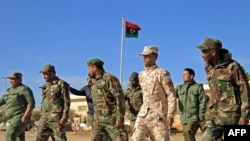 Fighters of a military battalion loyal to Libyan General Khalifa Haftar march during the morning assembly in the eastern city of Benghazi on Dec. 18, 2019. 