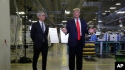Apple CEO Tim Cook and President Donald Trump speak during a tour of an Apple manufacturing plant, Nov. 20, 2019, in Austin, Texas. 