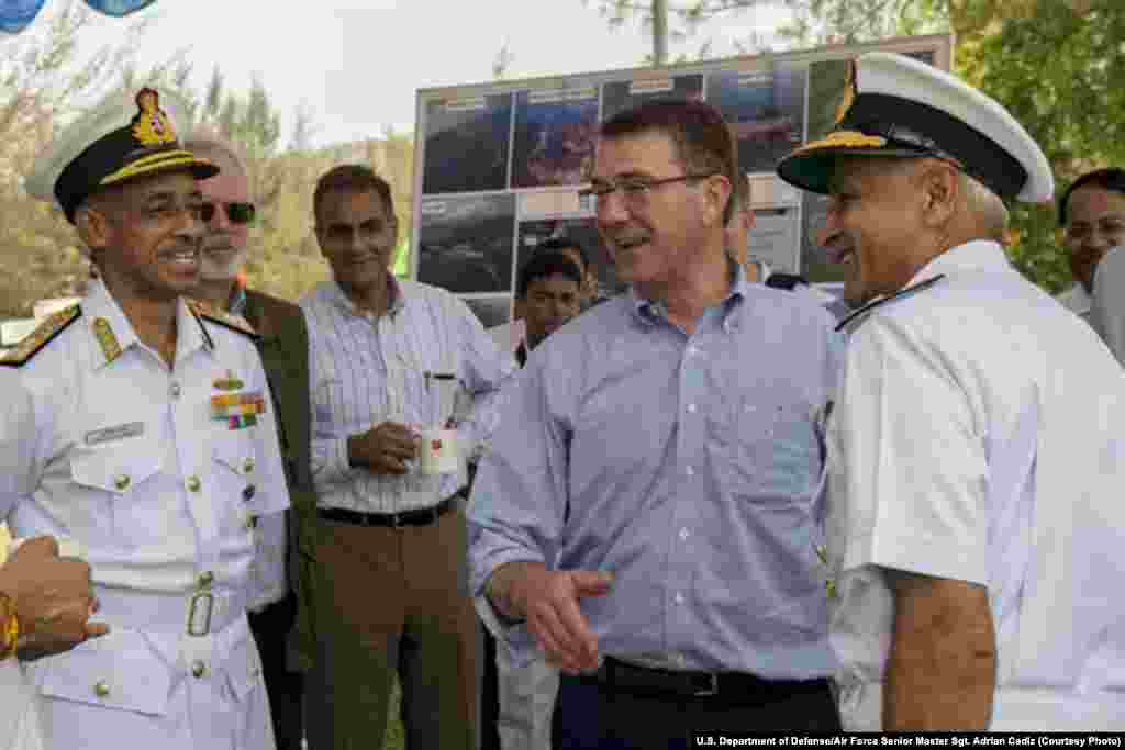 U.S. Defense Secretary Ash Carter, center right, laughs with Indian naval officers as he arrives at the Karwar naval base in India to visit the Indian aircraft carrier INS Vikramaditya, April 11, 2016.