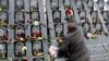 A man takes part in a commemoration ceremony, Nov. 21, 2019, at a monument to the "Heavenly Hundred," the anti-government protesters killed during the Ukrainian pro-European Union mass demonstrations in 2014, to mark the sixth anniversary of the uprising.