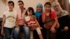 Syrian activist Soad Khadeya (third from right wearing a blue hijab) has opened her home near Cairo to other Syrian refugees, September 11, 2013. (Yuli Weeks for VOA)