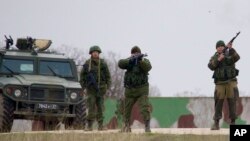 Russian soldiers fire warning shots at the Belbek air base, outside Sevastopol, Ukraine, March 4, 2014.