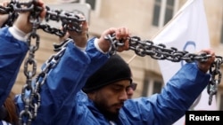 Para aktivis Amnesty International melakukan aksi protes atas berbagai pelanggaran HAM oleh pemerintah China terhadap warga minoritas Muslim Uighur dalam aksi di Paris, Prancis 26 Januari 2022 lalu (foto: dok). 