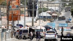 Somali security forces secure the road leading to the scene of an explosion at a checkpoint near the Presidential palace in Mogadishu, Somalia February 10, 2022.