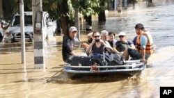 Tourists leave a flood-hit area in Chiang Mai Province, Thailand, Oct. 5, 2024.