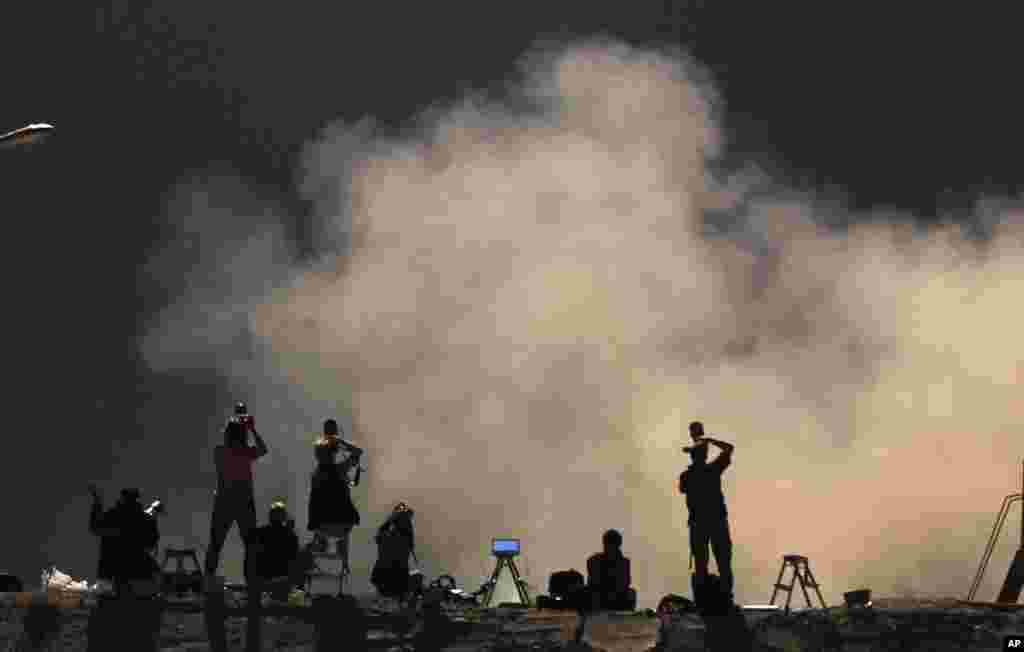 Photographers take pictures of the launch of Soyuz rocket booster with Soyuz space ship carrying a new crew to the International Space Station, May 29, 2013.