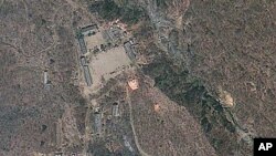 Satellite image provided by GeoEye appears to show a train of mining carts, at the lower center of the frame, and other preparations underway at North Korea's Punggye-ri nuclear test site but no indication of when a detonation might take place, April 18,