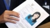 Thai Raksa Chart party leader Preechapol Pongpanich, holds up application of candidate for Prime Minister, Thailand's Princess Ubolratana Rajakanya Sirivadhana Barnavadi, at the election commission office in Bangkok, Thailand, Feb. 8, 2019. 