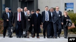 Syrian opposition chief negotiator Hadi al-Bahra (2nd R) and General Secretary of the Syrian National Council Badr Jamous (4ht R) arrive with the opposition delegation to attend a meeting at the "Geneva II" peace talks dedicated to the ongoing conflict in in Syria, in Geneva, Jan. 25, 2014.