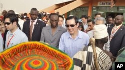 Taiwan's President Ma Ying-jeou (C) accompanied by Burkina Faso's Prime Minister Luc Adolph Tiao visits the vocational training center of reference (Centre de formation professionnelle de reference de Ziniare (CFPR-Z)) in Ziniare, 35kms of Ouagadougou on