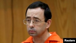 FILE - Larry Nassar, a former team USA Gymnastics doctor who pleaded guilty in November 2017 to sexual assault, listens to victims impact statements during his sentencing in the Eaton County Circuit Court in Charlotte, Mich., Jan. 31, 2018. 