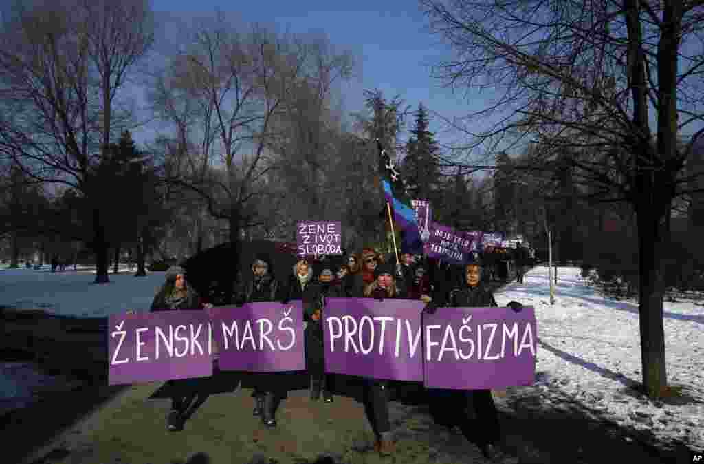 Activists hold a banner that reads "Women's March against Fascism" during the Women's March rally in Belgrade, Serbia, Saturday, Jan. 21, 2017. The march was held in solidarity with the Women's March on Washington, advocating women's rights and opposing Donald Trump's presidency. (AP Photo/Darko Vojinovic)