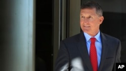 FILE - Former Trump national security adviser Michael Flynn leaves federal courthouse in Washington, July 10, 2018, following a status hearing.