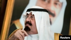 FILE - Saudi King Abdullah bin Abdul Aziz al-Saud sits before a meeting with U.S. Secretary of State John Kerry at the Royal Palace, Jeddah, Sept. 11, 2014.